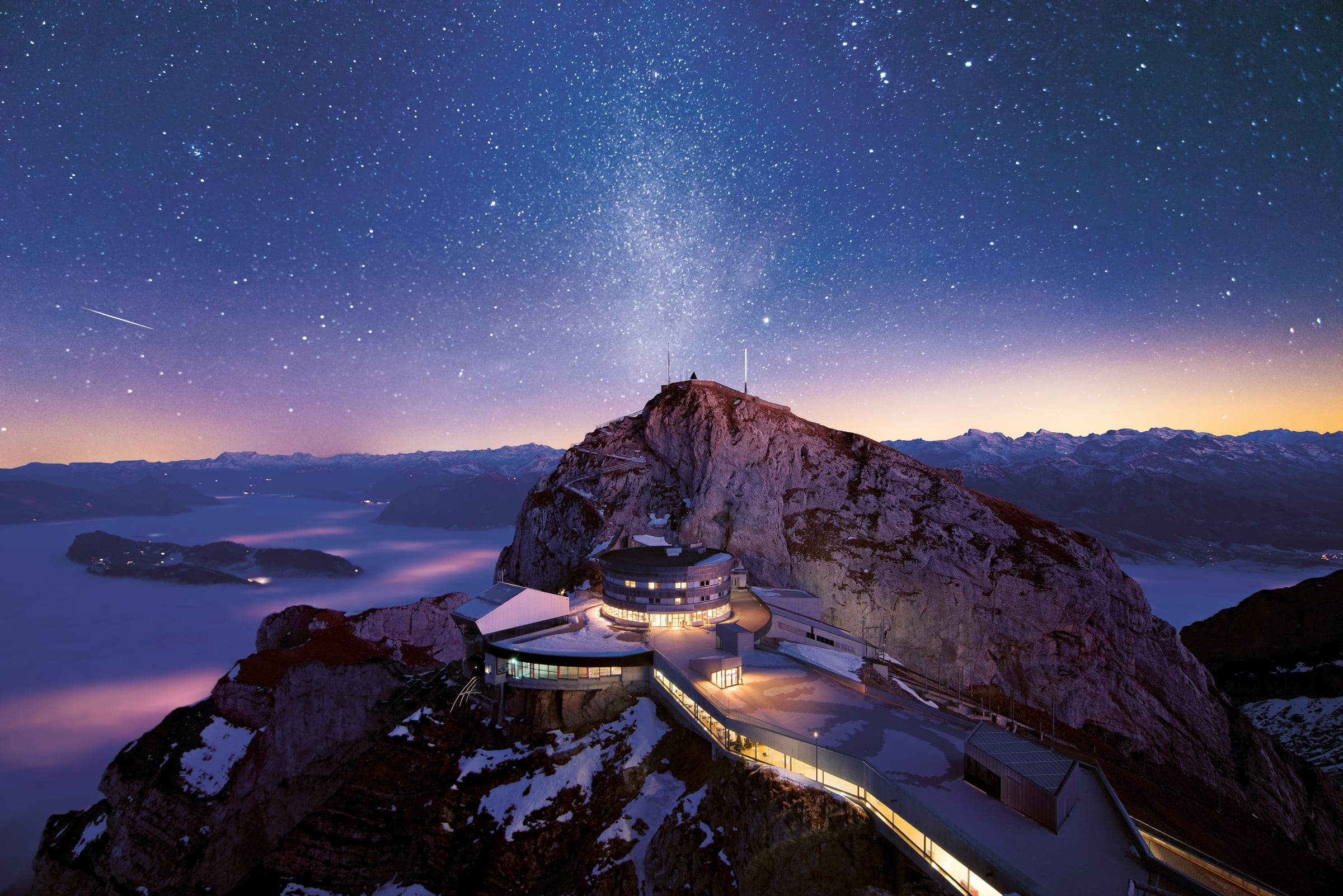 Pilatus Kulm summit buildings at night under the Milky Way