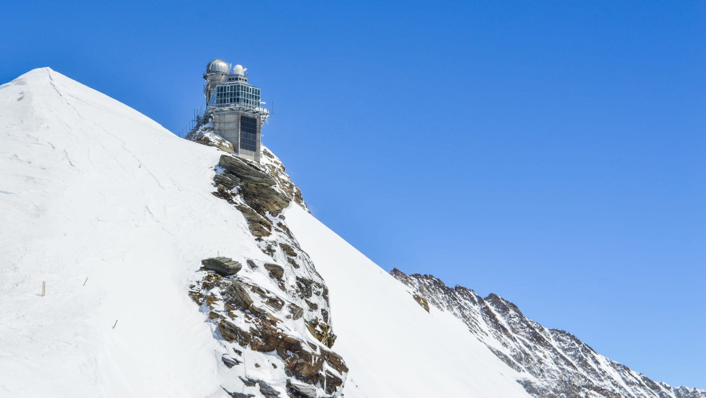 Sphinx Observatory on a snow-covered ridge at Jungfraujoch
